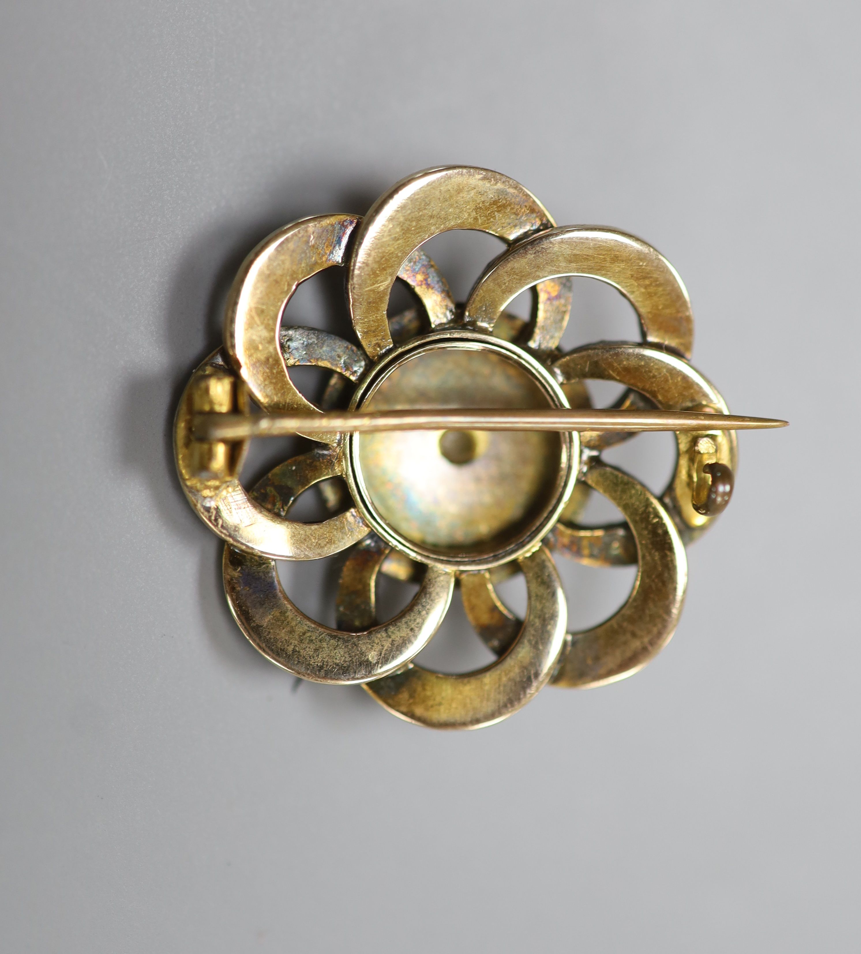 An early 20th century yellow metal and seed pearl set circular cluster brooch, 27mm
